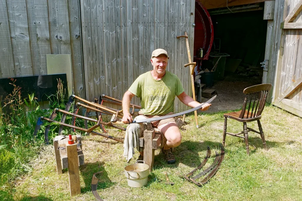 Kevin on peening stool peening scythe blade
